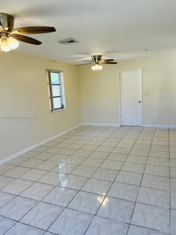 a kitchen with granite countertop a white cabinets and white appliances