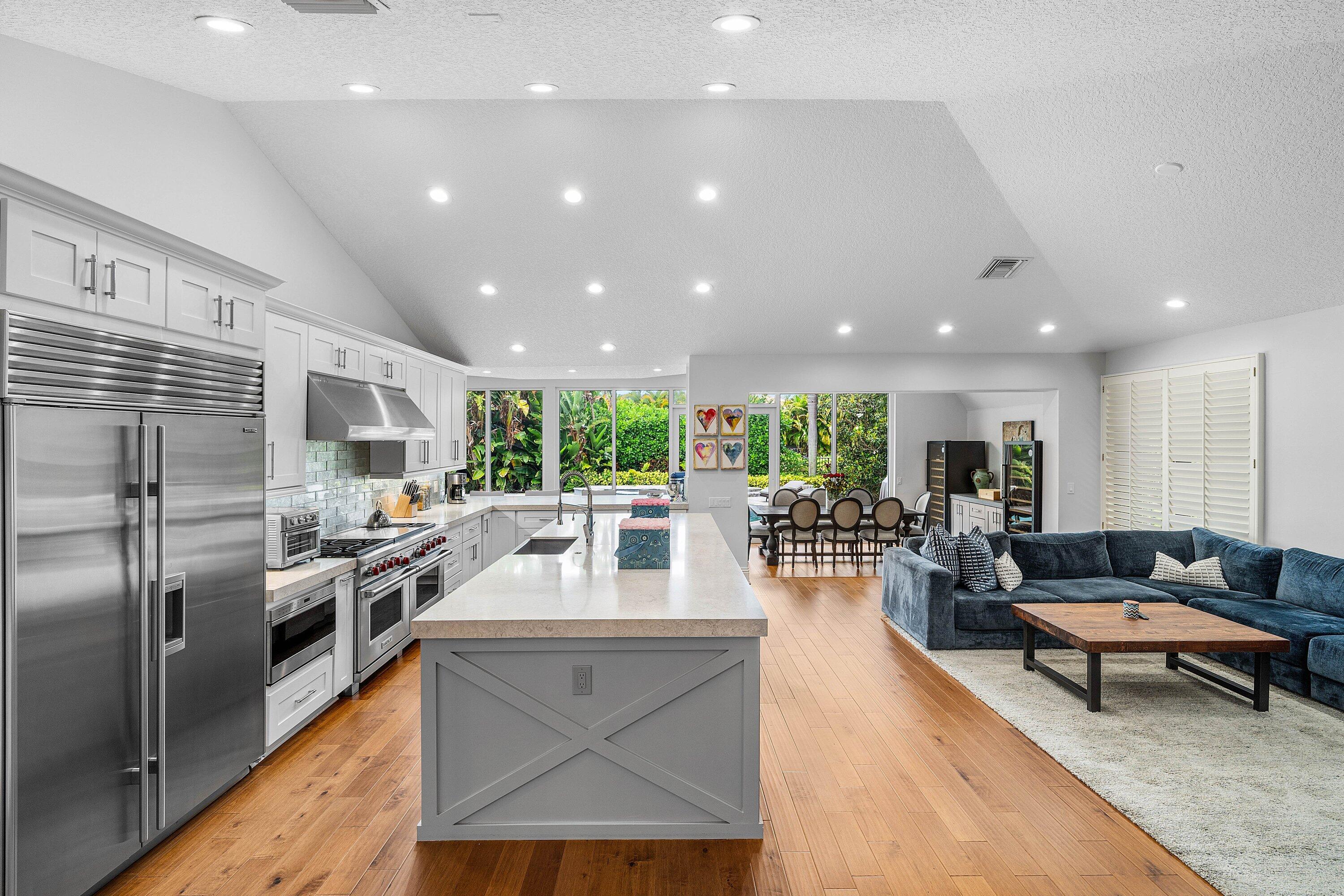 2357 Northwest 59th Street Boca Raton, FL 33496 - Photo 16 of 88 a living room with stainless steel appliances furniture wooden floor and a kitchen counter top