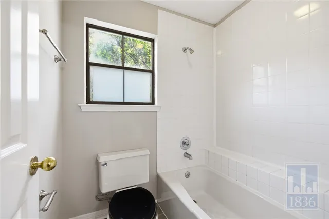 a bathroom with a bathtub sink and mirror