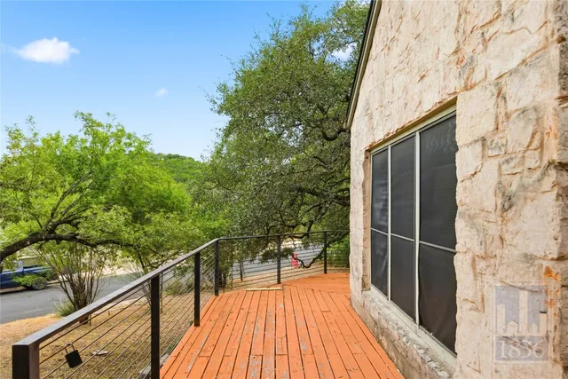 a view of balcony with wooden floor and fence