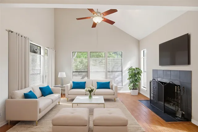 a living room with furniture a fireplace and a flat screen tv