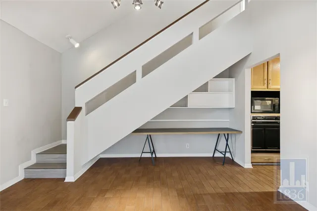a view of entryway and hall with wooden floor