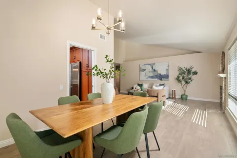 a view of a dining room with furniture and chandelier