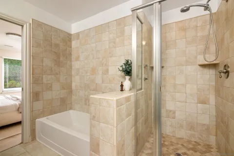 a bathroom with a bathtub and shower