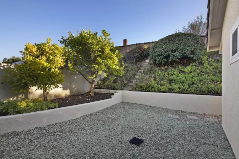 an aerial view of a house with garden space and street view