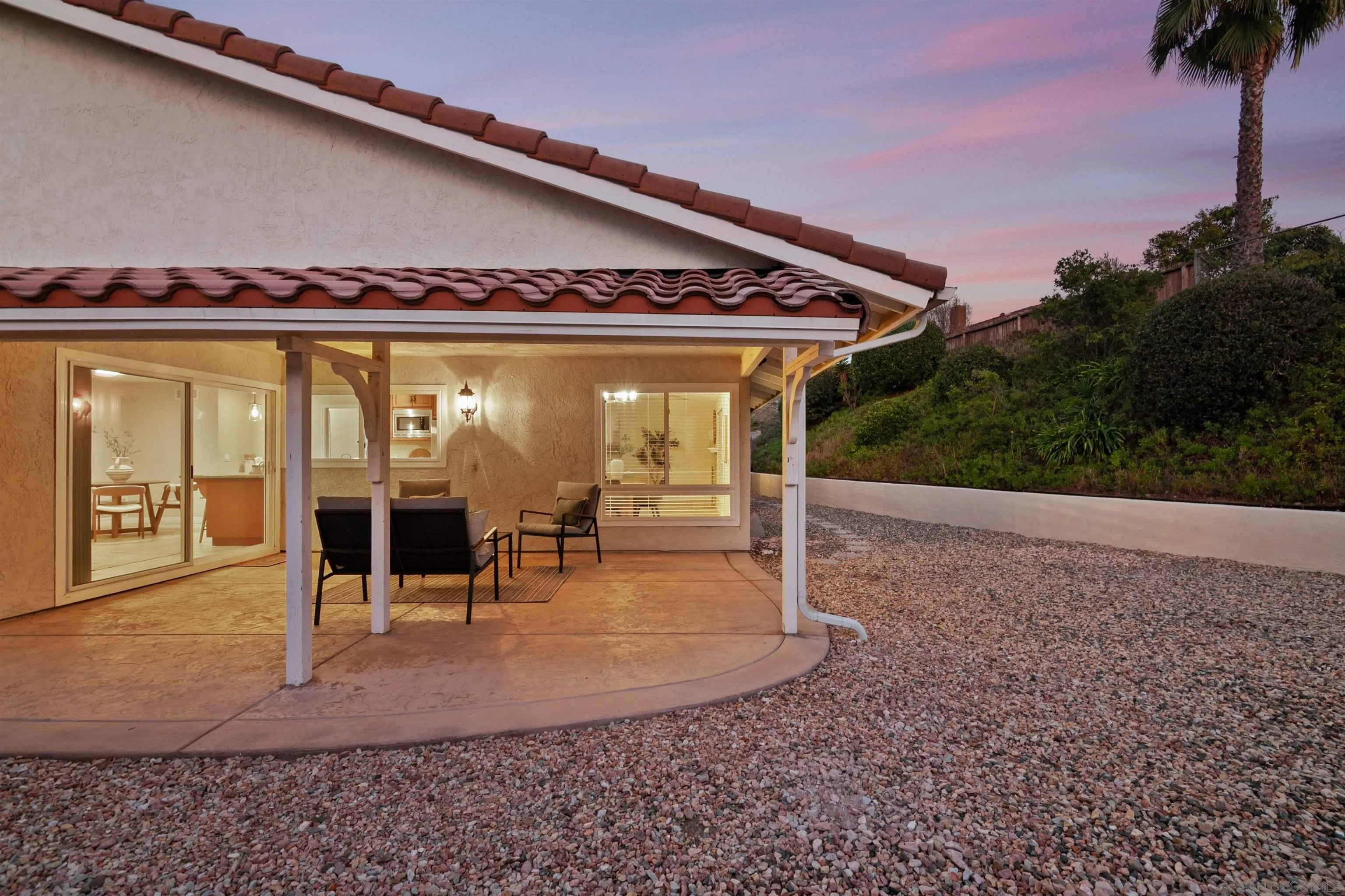12607 Opimo Drive San Diego, CA 92128 - Photo 4 of 48 a view of a swimming pool with lawn chairs and floor to ceiling window