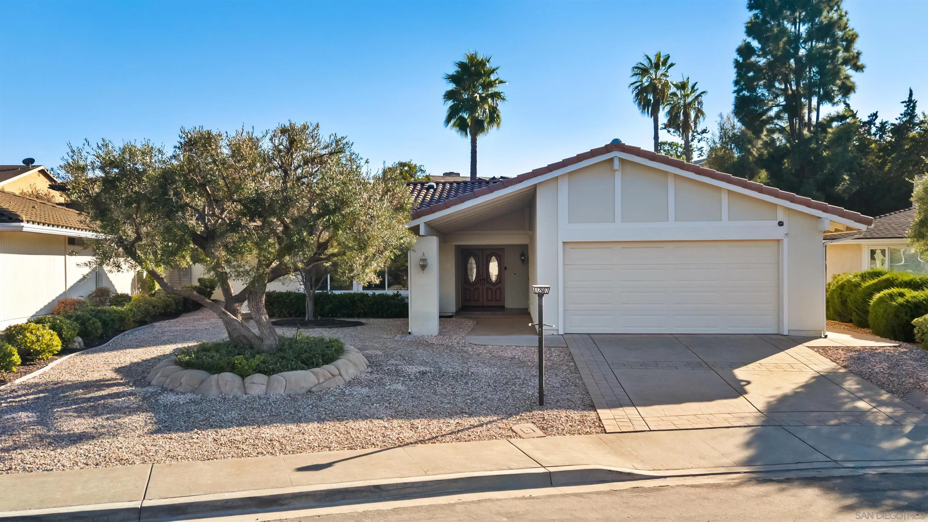 12607 Opimo Drive San Diego, CA 92128 - Photo 42 of 48 a front view of a house with garage
