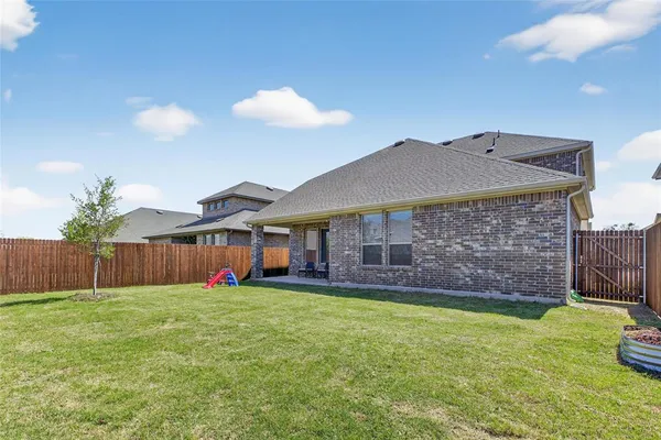 a view of a house with a yard and sitting area