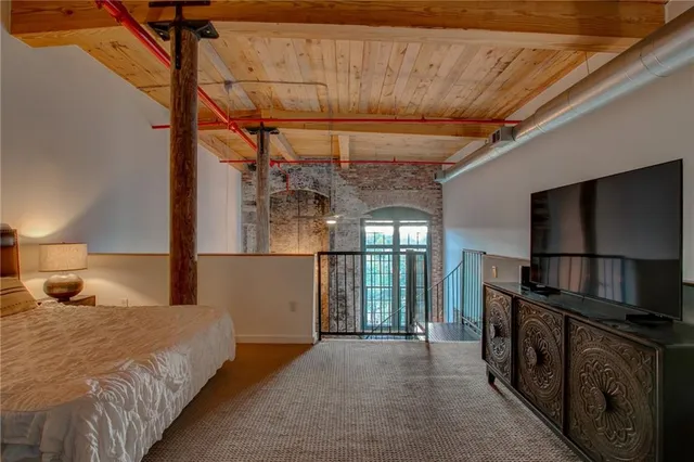 a bedroom with a bed and a night stand