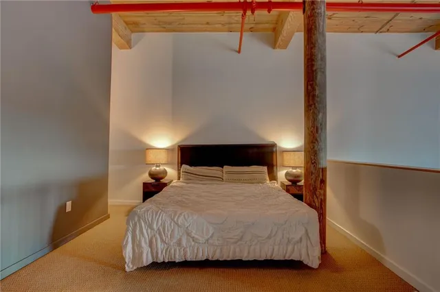 a living room with a couch and a potted plant