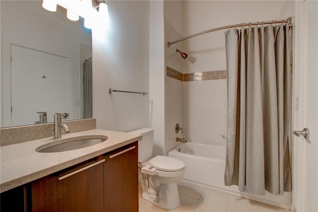 170 Boulevard Southeast, Unit E404 Atlanta, GA 30312 - Photo 18 of 42 a bathroom with a sink a toilet a mirror and shower
