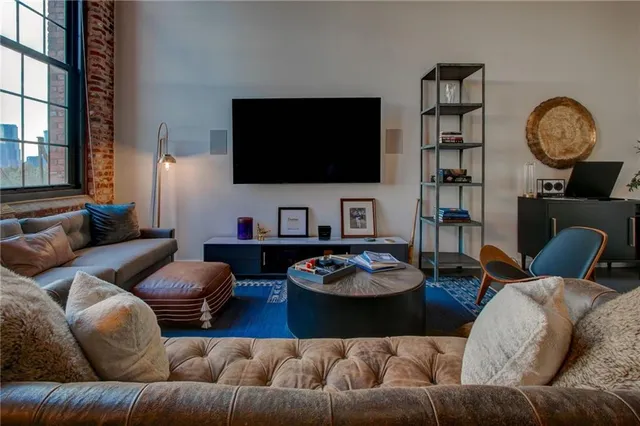 a living room with furniture gym equipment and a flat screen tv