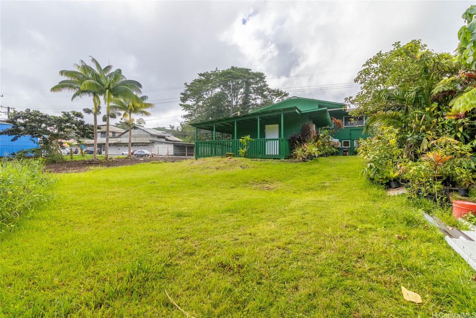 15-2885 Pahoa Village Road Pahoa, HI 96778 - Photo 19 of 25 a view of a swimming pool with lawn chairs under an umbrella
