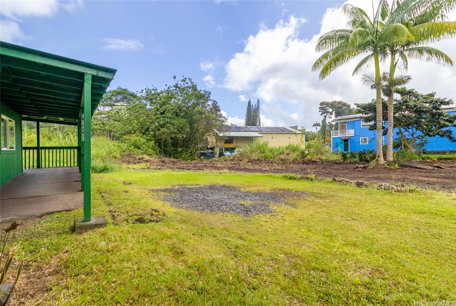 15-2885 Pahoa Village Road Pahoa, HI 96778 - Photo 22 of 25 a view of a swimming pool with a lawn chairs and palm trees