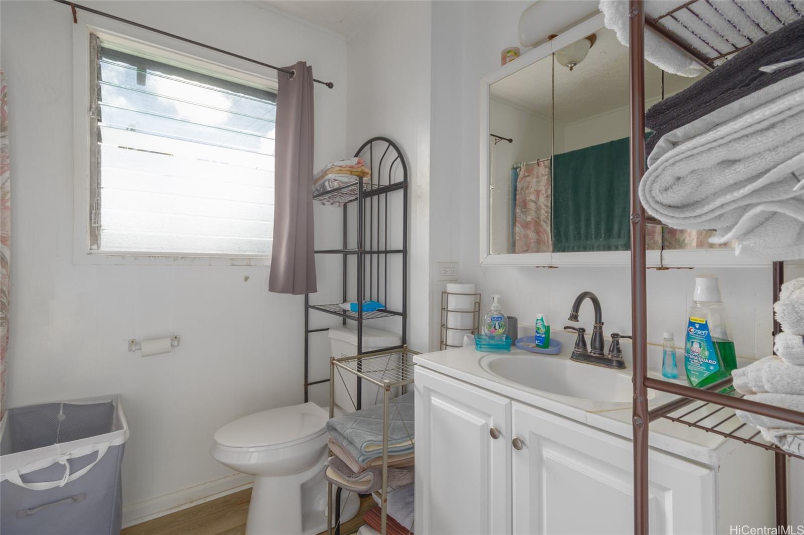 15-2885 Pahoa Village Road Pahoa, HI 96778 - Photo 6 of 25 a bathroom with a toilet sink and mirror