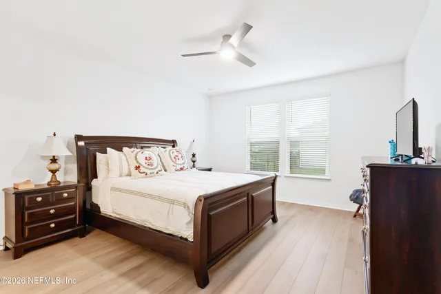 a bedroom with a bed and a tv on the dresser