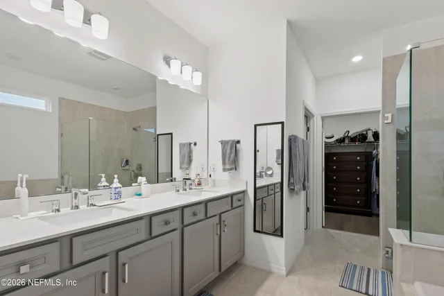 a bathroom with a double vanity sink and a mirror