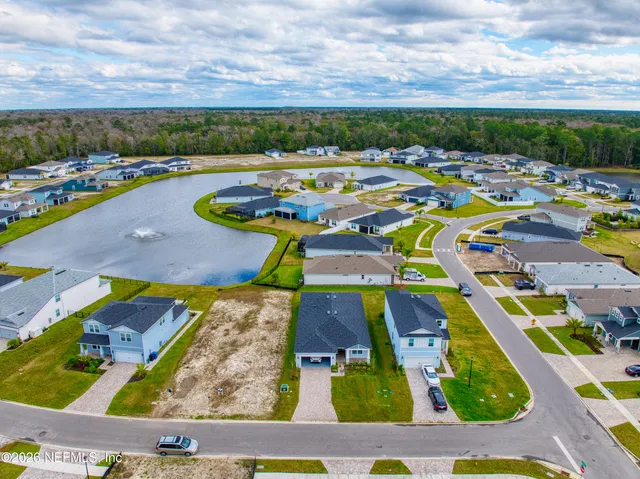 an aerial view of a swimming pool with outdoor seating