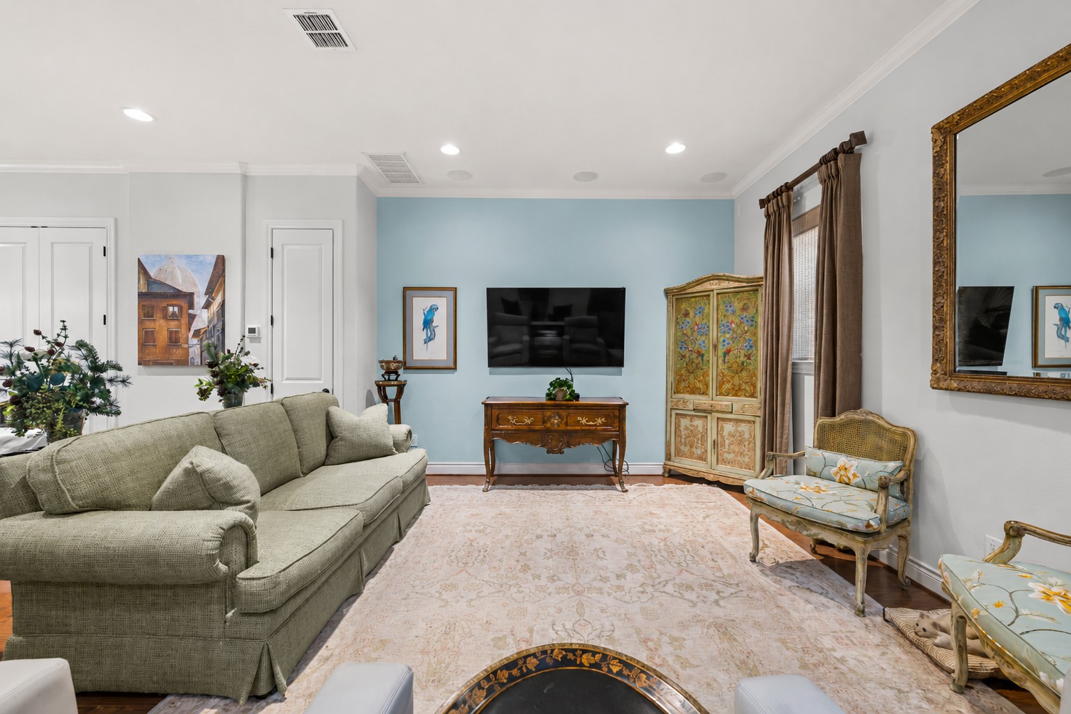 204 Adams Street Georgetown, TX 78628 - Photo 10 of 33 Hardwood flooring complements crown molding and recessed lighting throughout this inviting living space.
