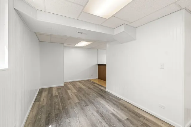 a view of empty room with wooden floor