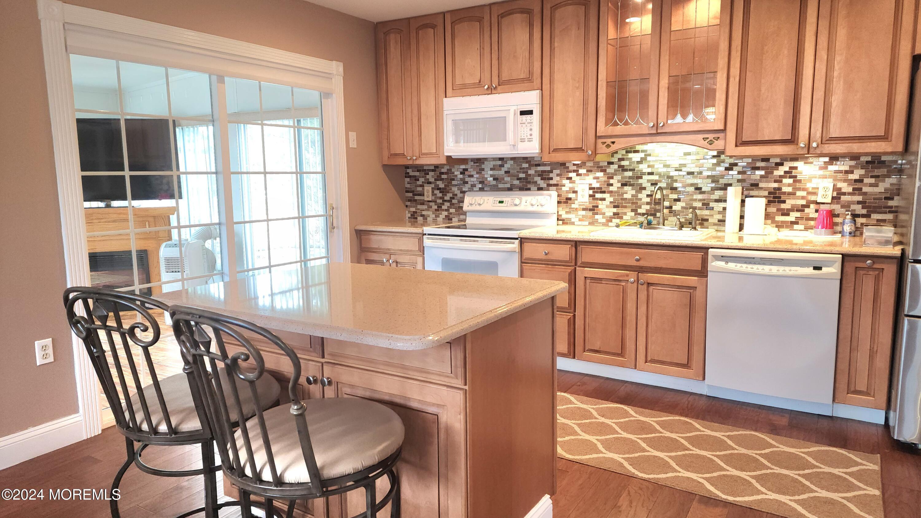 1 Ohio Drive, Unit B Whiting, NJ 08759 - Photo 18 of 37 a kitchen with a sink a table and chairs