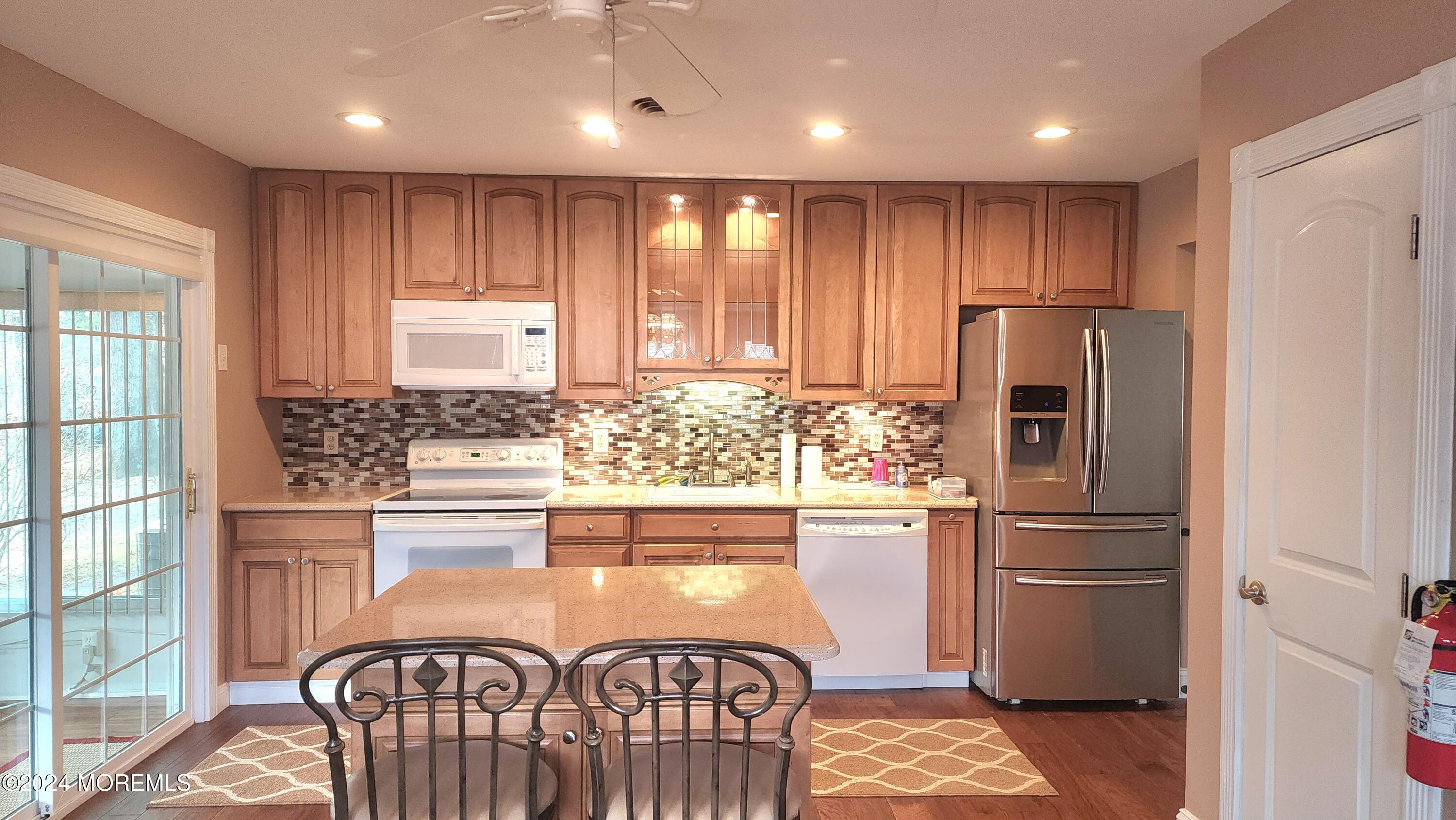 1 Ohio Drive, Unit B Whiting, NJ 08759 - Photo 19 of 37 a kitchen with stainless steel appliances granite countertop a refrigerator and a stove