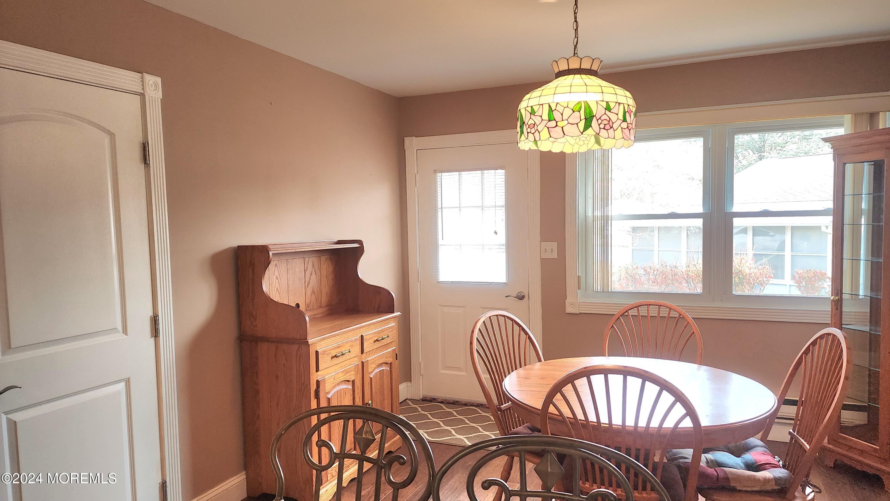 1 Ohio Drive, Unit B Whiting, NJ 08759 - Photo 20 of 37 a dining room with furniture a chandelier and wooden floor