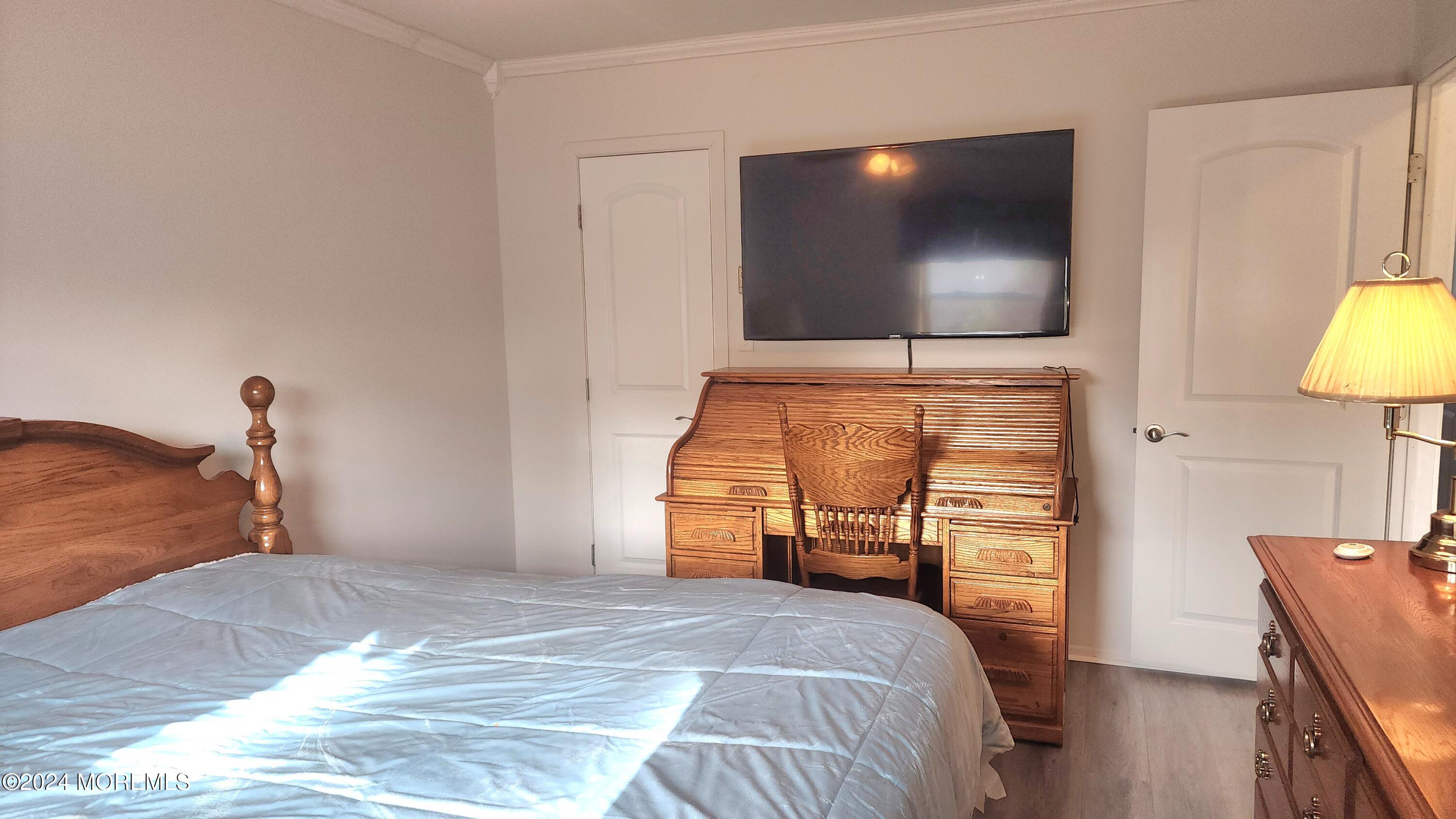 1 Ohio Drive, Unit B Whiting, NJ 08759 - Photo 33 of 37 a bedroom with a bed and a flat screen tv