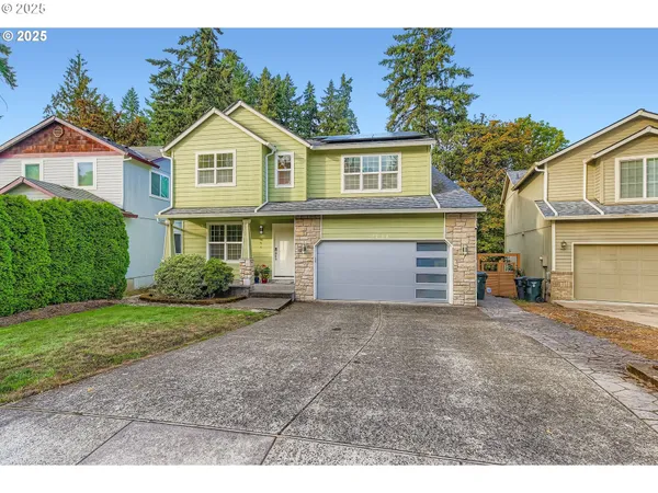 a front view of a house with a yard and garage