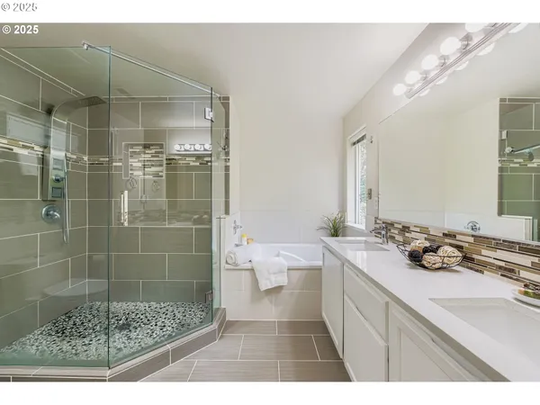 a bathroom with a shower sink and mirror