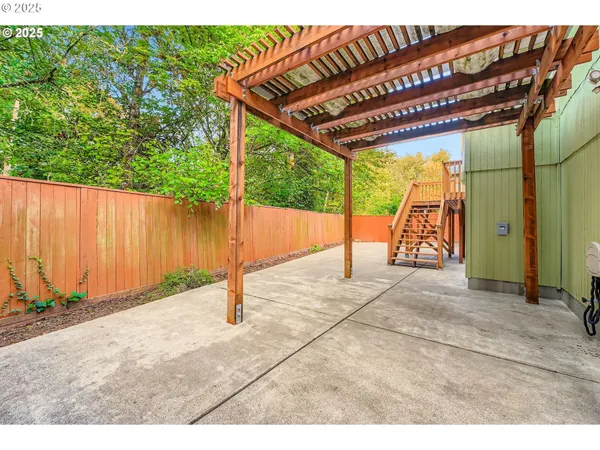 a view of a backyard with wooden fence