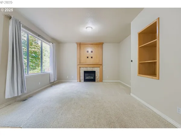 a view of empty room with a fireplace