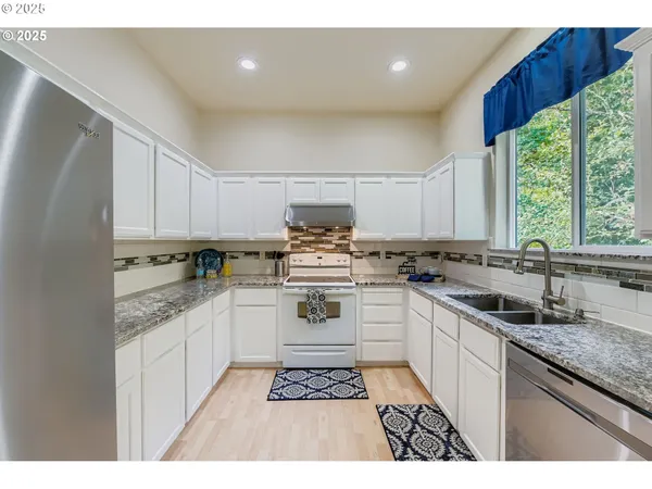 a kitchen with a sink stove and cabinets