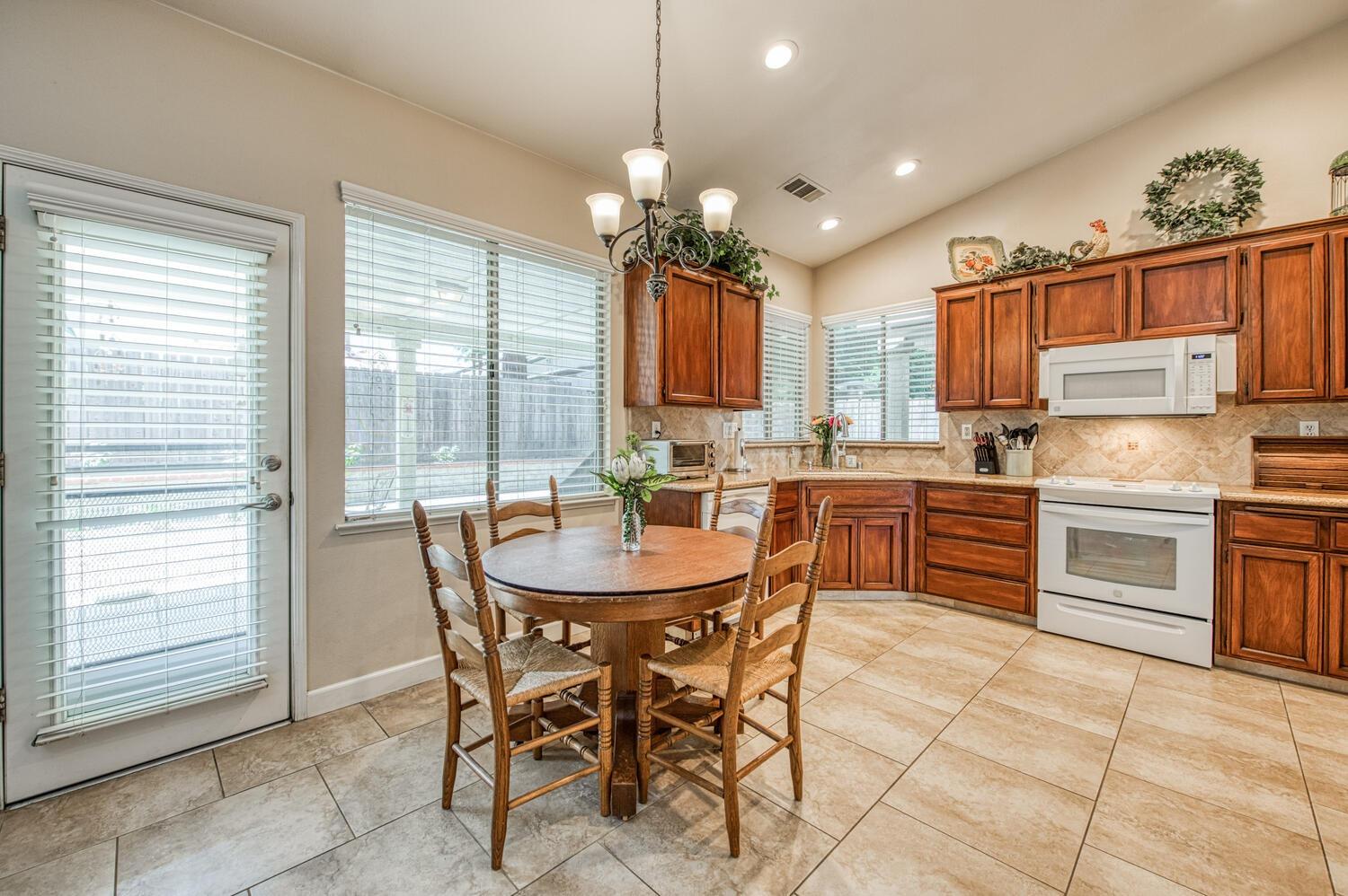 2512 Keats Avenue Clovis, CA 93611 - Photo 19 of 39 a kitchen with stainless steel appliances granite countertop a stove top oven a sink a counter space and cabinets
