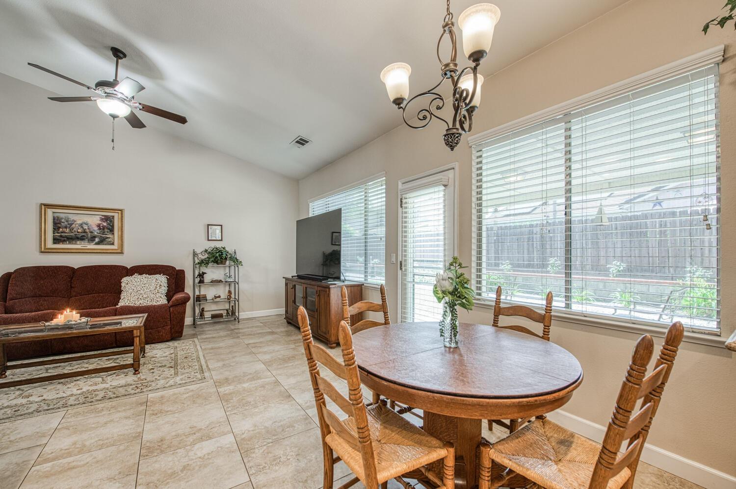 2512 Keats Avenue Clovis, CA 93611 - Photo 20 of 39 a dining room with furniture a chandelier and window