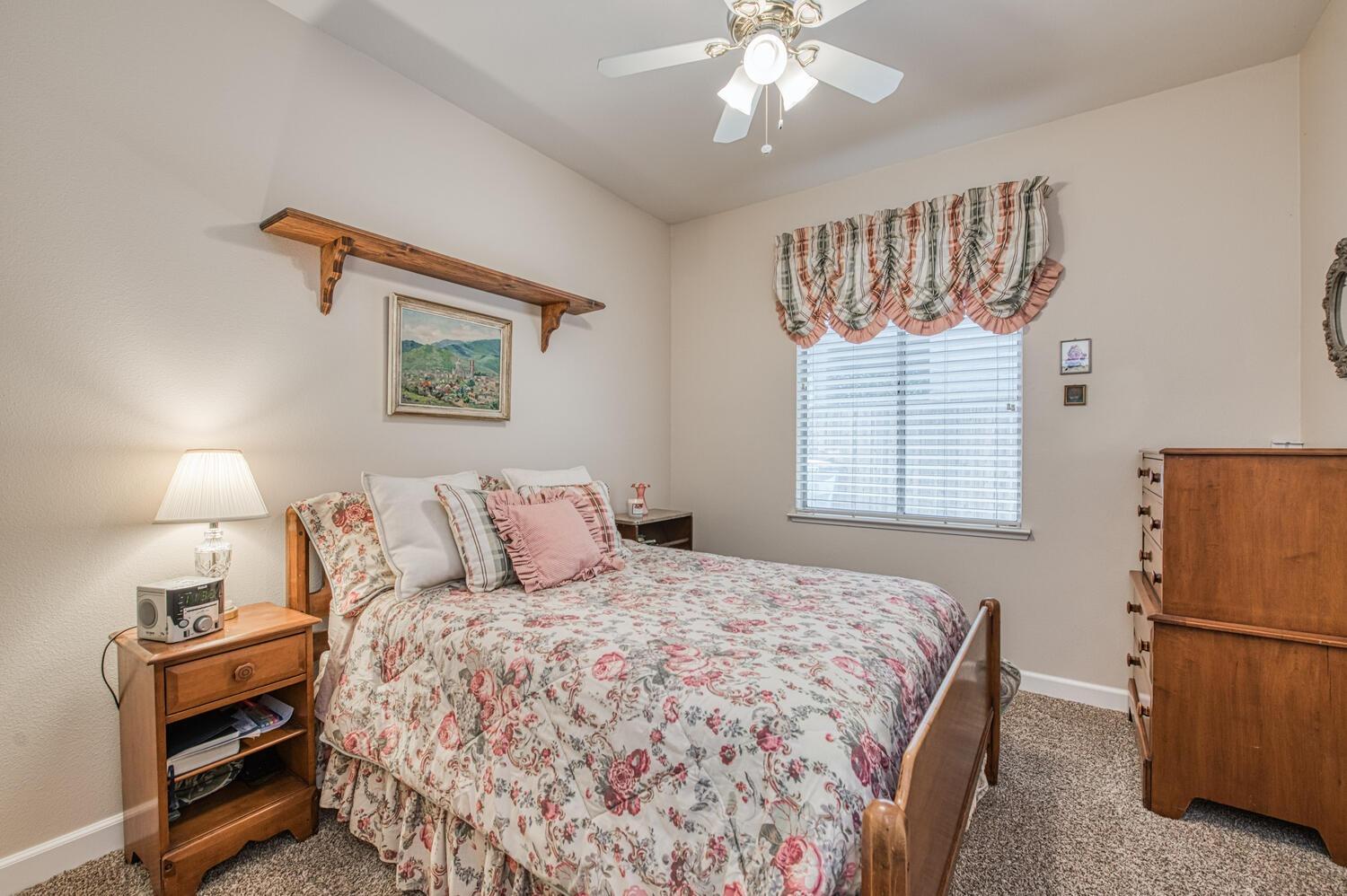 2512 Keats Avenue Clovis, CA 93611 - Photo 26 of 39 a bedroom with a bed and a chandelier