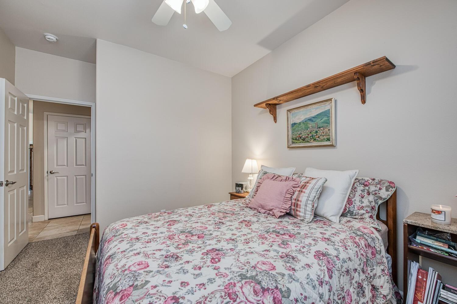 2512 Keats Avenue Clovis, CA 93611 - Photo 27 of 39 a bedroom with a bed and a painting on the wall