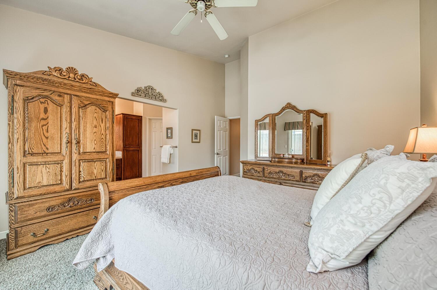 2512 Keats Avenue Clovis, CA 93611 - Photo 31 of 39 a bedroom with a large bed and a chandelier