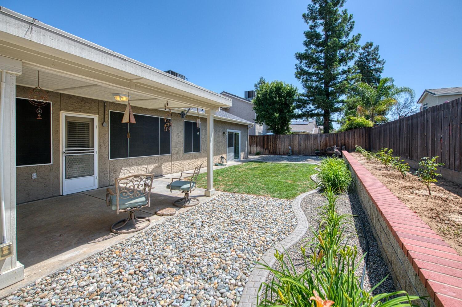 2512 Keats Avenue Clovis, CA 93611 - Photo 36 of 39 a view of a patio with table and chairs next to a yard