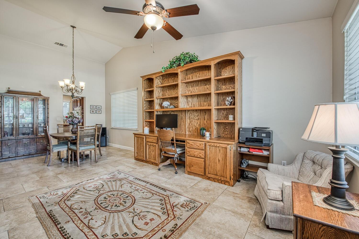 2512 Keats Avenue Clovis, CA 93611 - Photo 10 of 39 a living room with furniture a rug and a chandelier