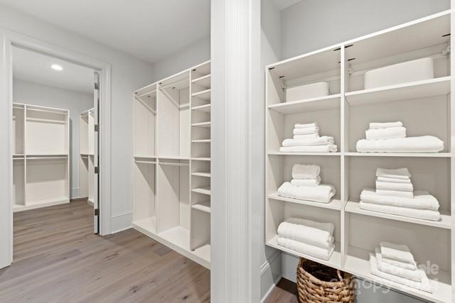 1500 Queens Road, Unit 301 Charlotte, NC 28207 - Photo 11 of 12 a view of a room with shelves and wooden floor