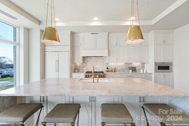 1500 Queens Road, Unit 301 Charlotte, NC 28207 - Photo 2 of 12 a kitchen with stainless steel appliances granite countertop a stove a sink a microwave a refrigerator and white cabinets