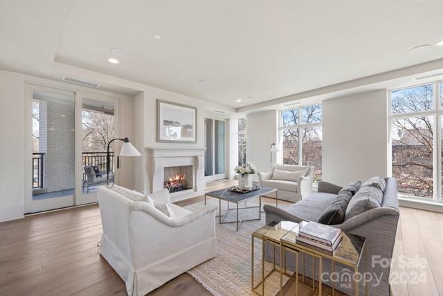 1500 Queens Road, Unit 301 Charlotte, NC 28207 - Photo 6 of 12 a living room with fireplace furniture and a large window