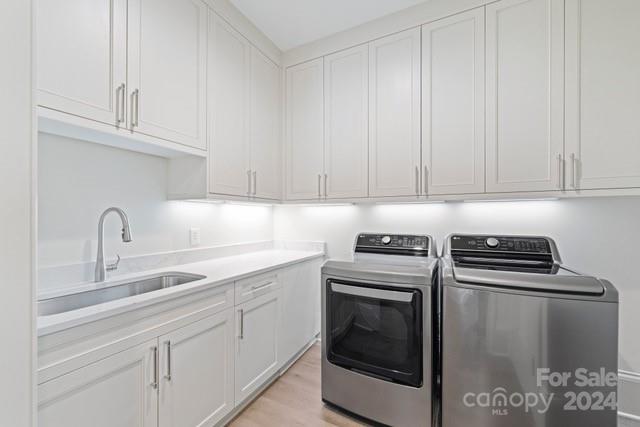1500 Queens Road, Unit 301 Charlotte, NC 28207 - Photo 10 of 12 a kitchen with cabinets appliances and a sink