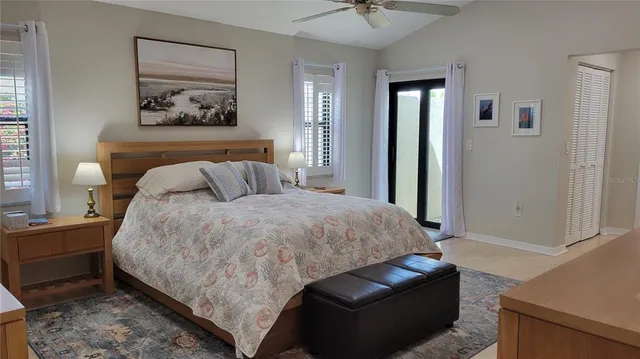 a bedroom with a bed and painting on the wall