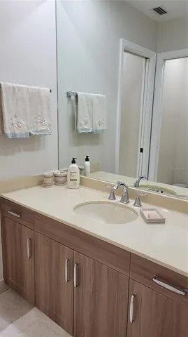 a bathroom with a double vanity sink and a mirror