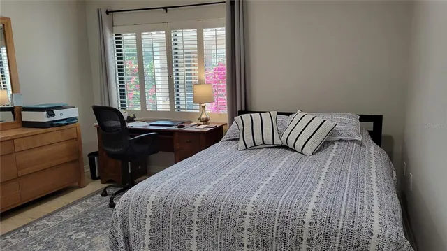 a bedroom with a bed and window