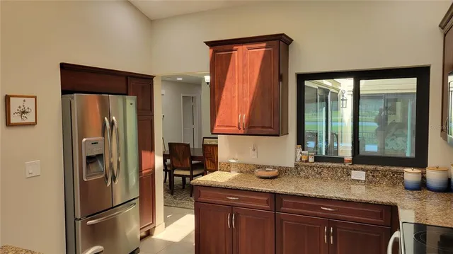 a kitchen with stainless steel appliances granite countertop a refrigerator and a sink