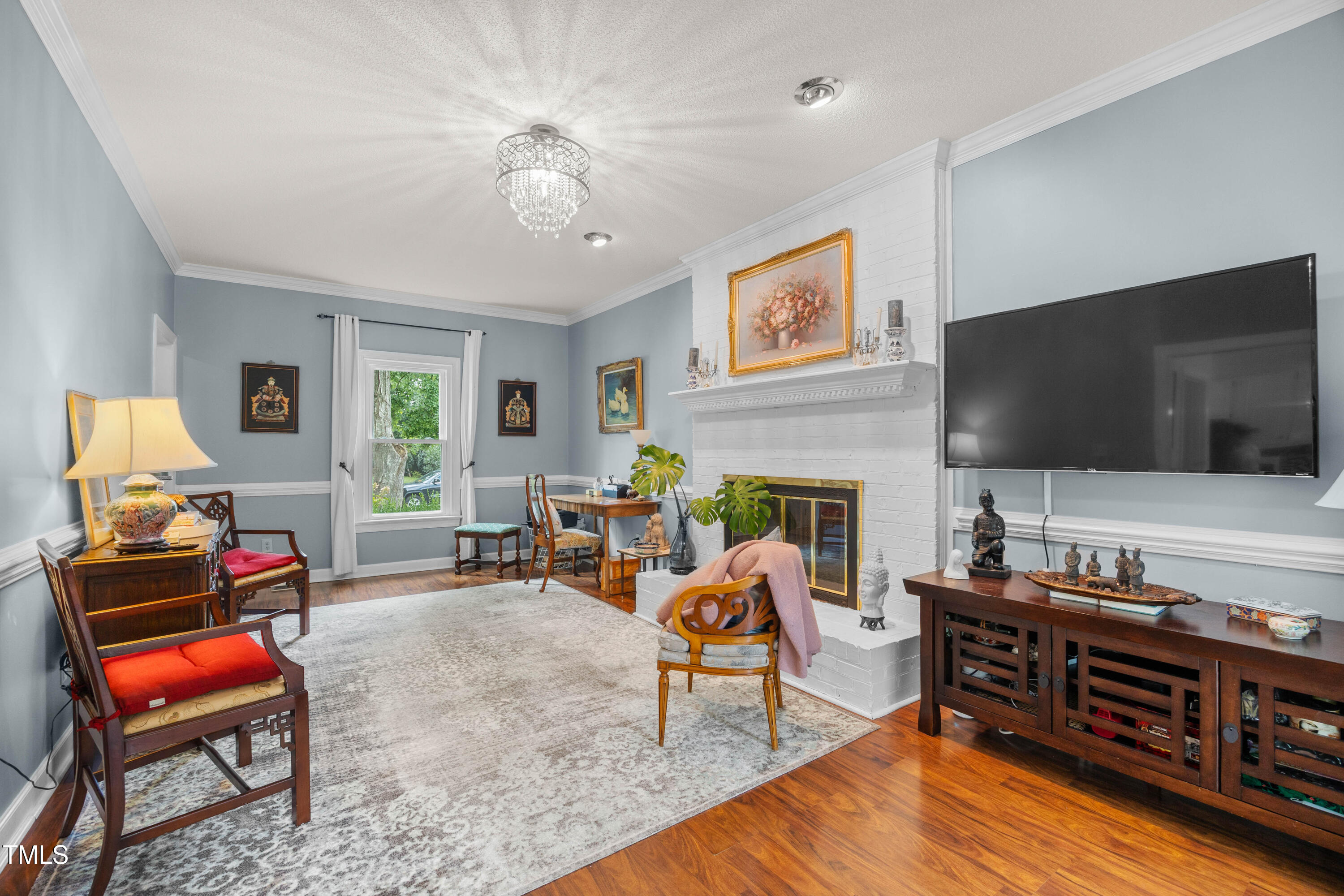 207 Wintermist Drive Cary, NC 27513 - Photo 13 of 43 a living room with furniture and a flat screen tv