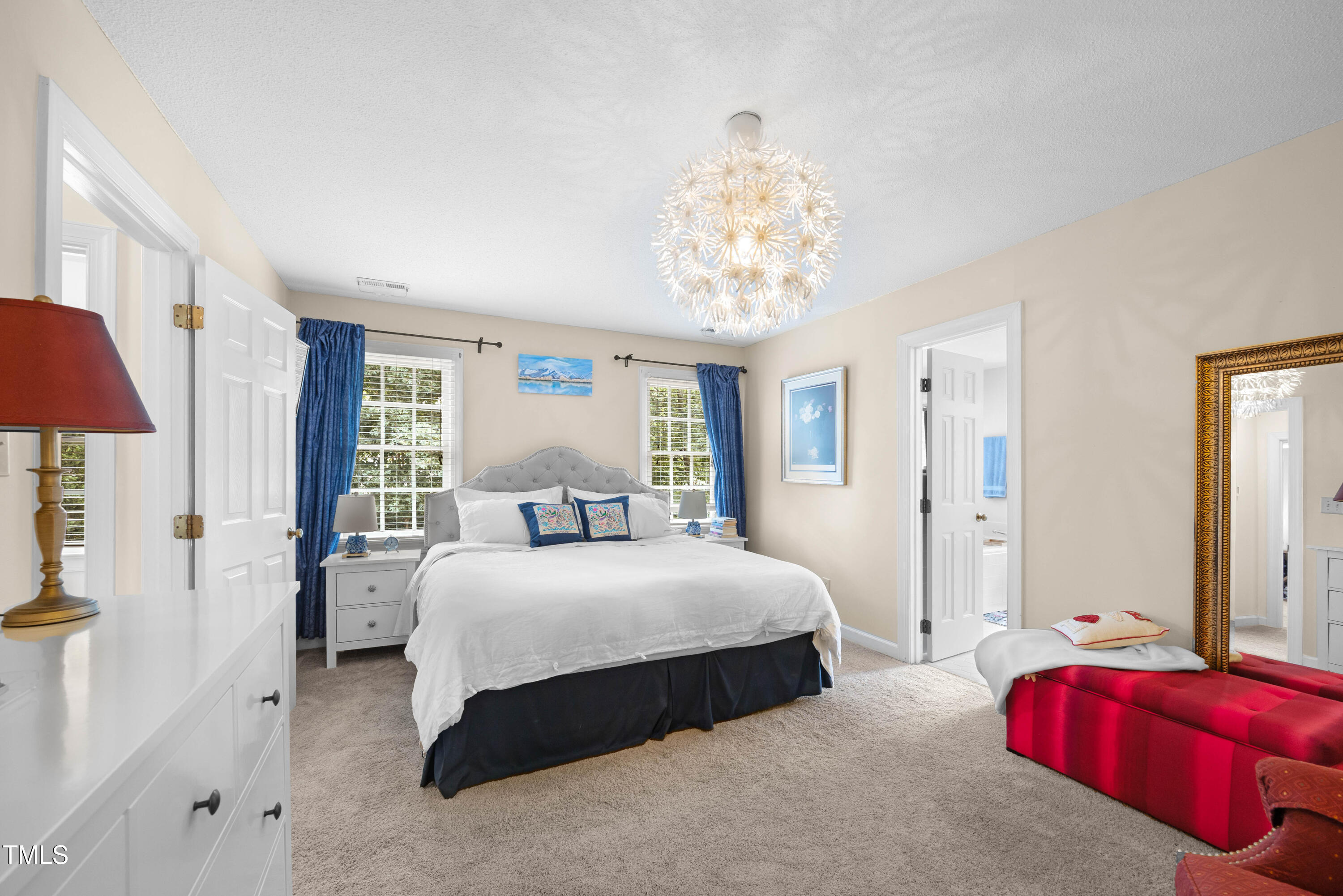 207 Wintermist Drive Cary, NC 27513 - Photo 20 of 43 a bedroom with a bed and a chandelier